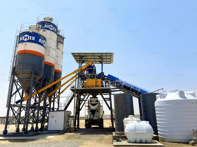 concrete mixer truck taking finished product from stationary batching plant