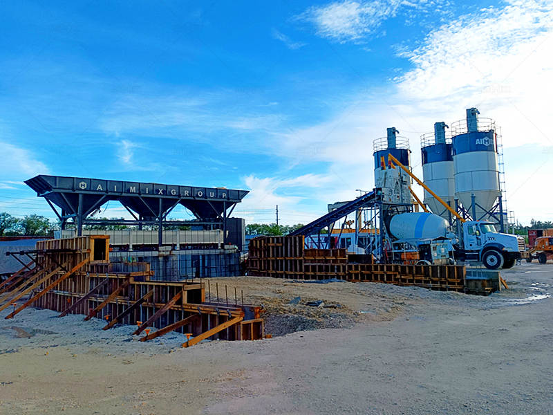 mixer truck getting dry material mix from dry mix concrete batch plant